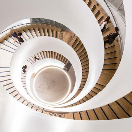 Students descending building 2 helix staircase