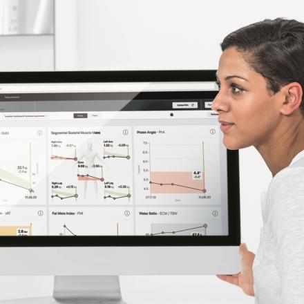 Female doctor. Computer screen with graphs.