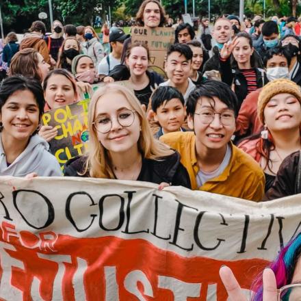 A group of people holding up a banner