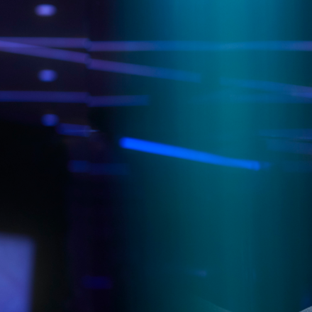 Dark background with blue and purple neon lights in rods and spheres