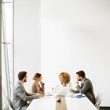 Group of colleagues talking in meeting room