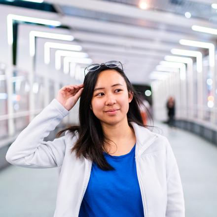 International student stands on the Barangaroo Pedestrian Bridge at night