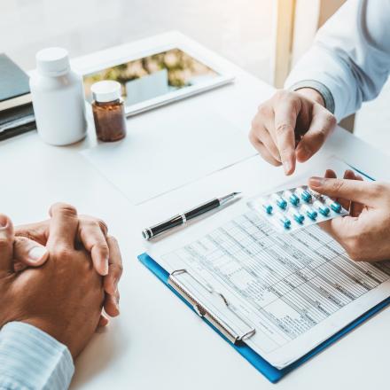 Doctor recommending pills to patient