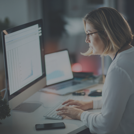 Women at computer looking at spreadsheets