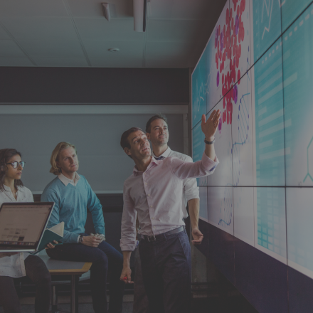 People discussing content on a large screen