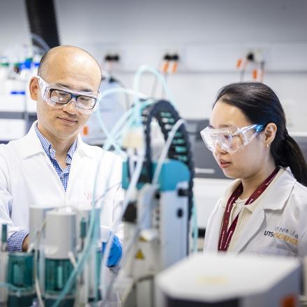 Two researchers in a laboratory looking at an experiment