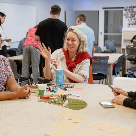 People sitting around a table working together on a creative exercise