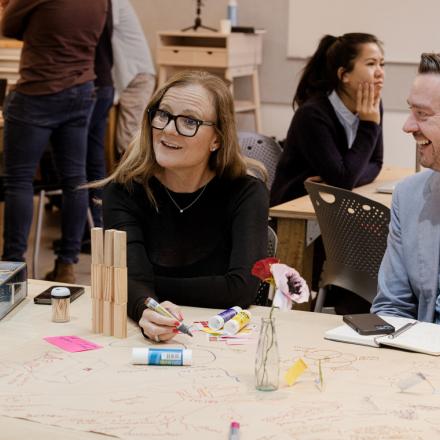 Happy people sitting at a table during a creativity exercise