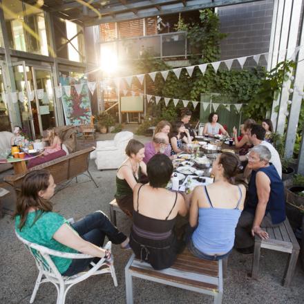 A group of people sit around a table talking