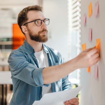 student with sticky notes on a wall