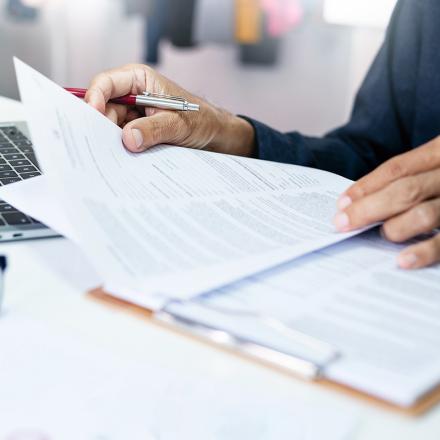 Person reviewing document reports at an office