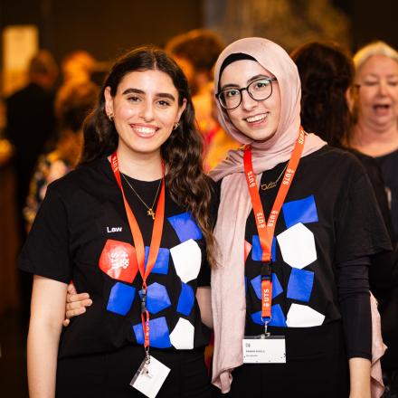 Two Brennan students in UTS law t-shirts at an event