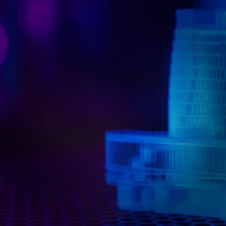 Close up image of 3d printed part being cured with ultra-violet light