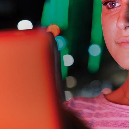 Close up of woman looking at laptop screen