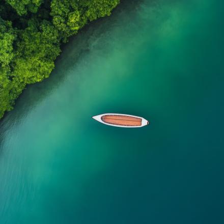 Aerial shot of a long boat in the river
