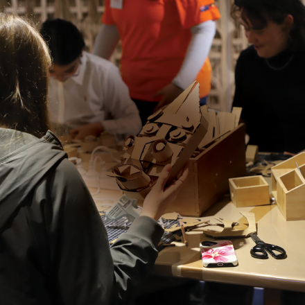 Student making a mask out of cardboard