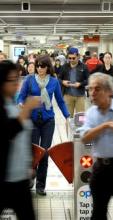 Photo of commuters walking through ticket gates at a railway station