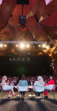 Onstage at a WMN panel discussion with a big crowd in the UTS Great Hall