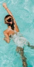 Swimmer in turquoise coloured swimming pool