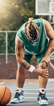 Basketball player on the court holding their knee