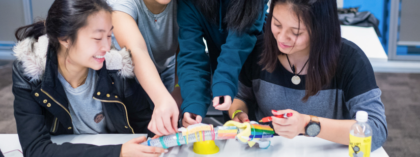 A group of girls work on build a prosthetic limb