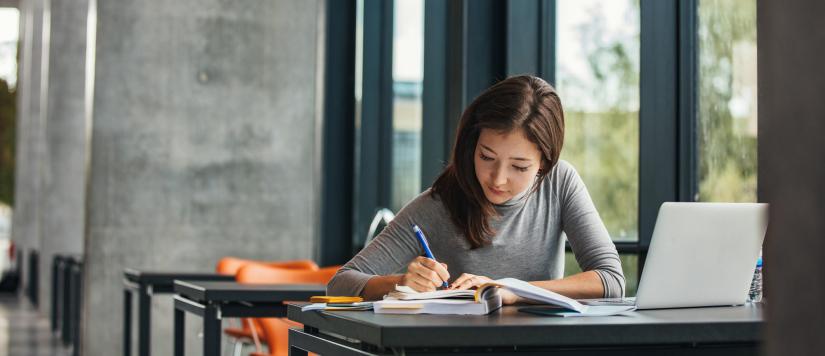 Female student sitting at desk studying