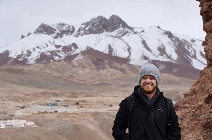 Mark Isaac in Afghanistan standing in front of mountains