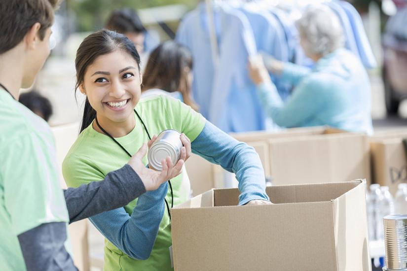 A woman volunteers at a charity food drive