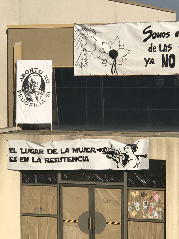 FASS Chile ICS study tour technological institute posteres and political flyers at the protest