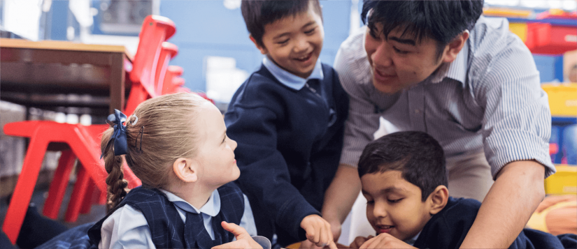 Male student teacher with 3 primary school students