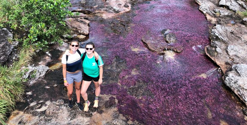 Alayna and a female frined standing at the edge of the river