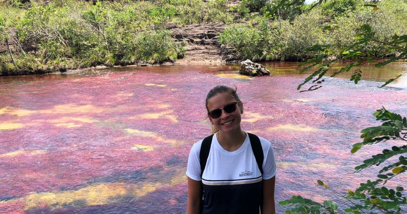 Alayna smiling with the river landscape behind her