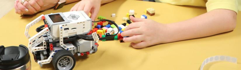 Lego Mindstorm robot and child's hands