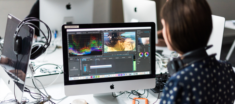 A student editing a film in a computer lab