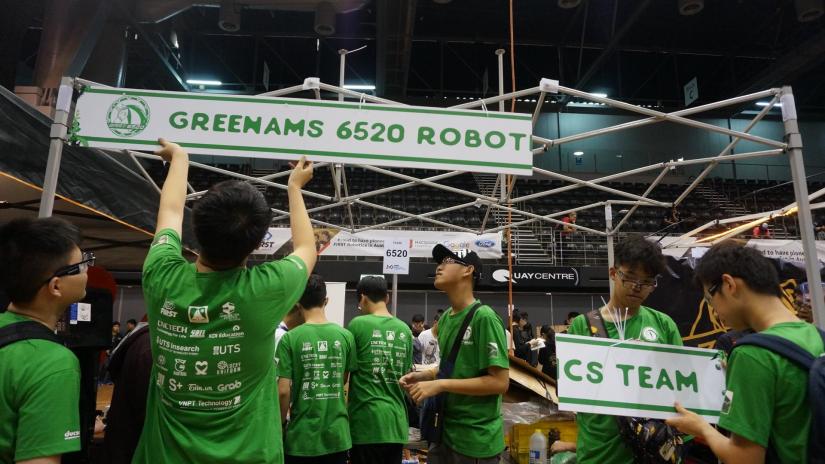 A group of people hoist a banner