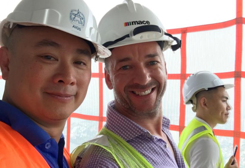 Michael Er and David McDonald wear safety gear on a construction site