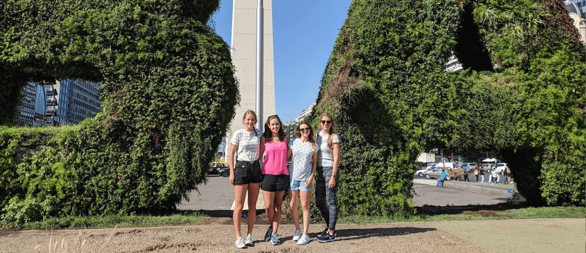 Alana and her friends standing in front of a Buenos Aires sign