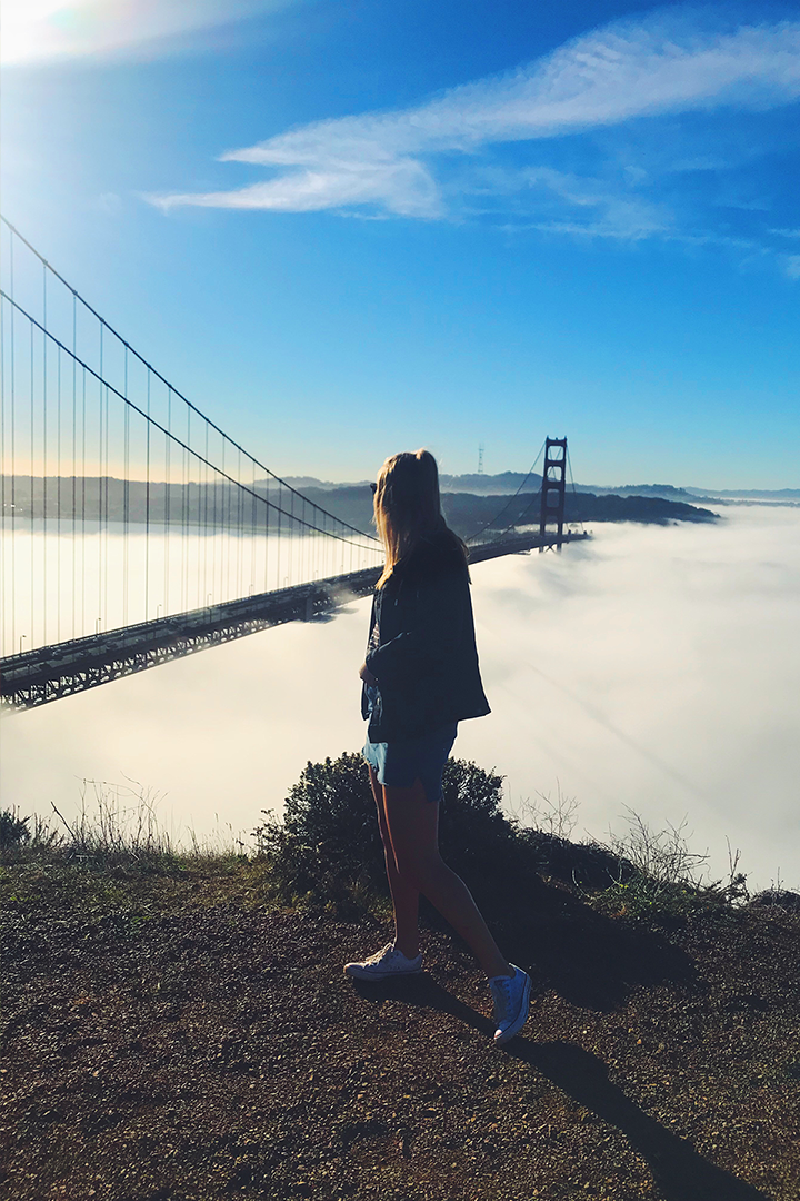 Alana posing next to a bridge