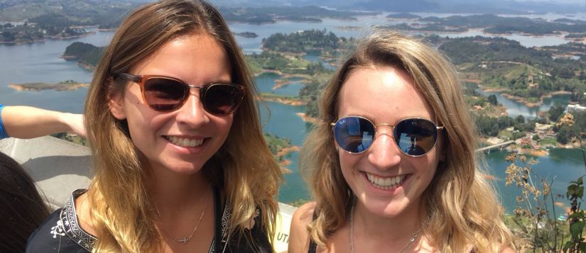 Alayna and a friend posing in front of a view in a Colombia