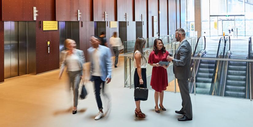 People standing in the foyer of building 11