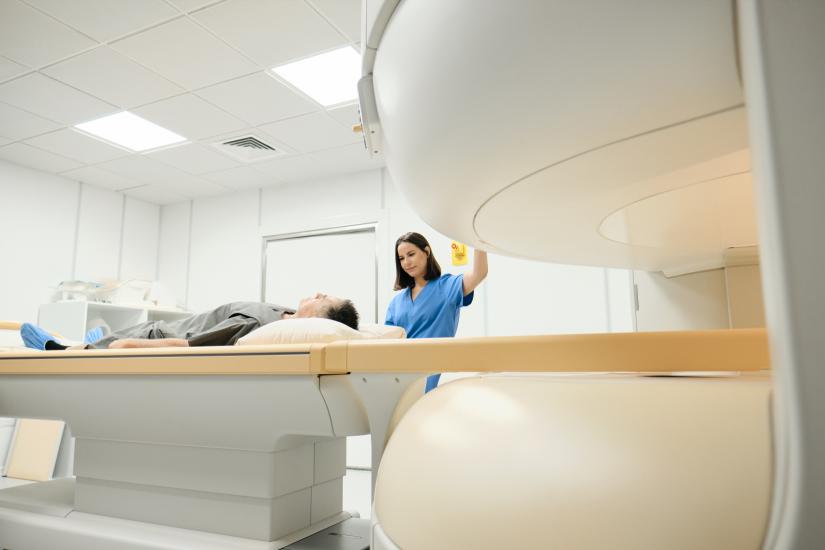Medical worker preparing a patient for a scan