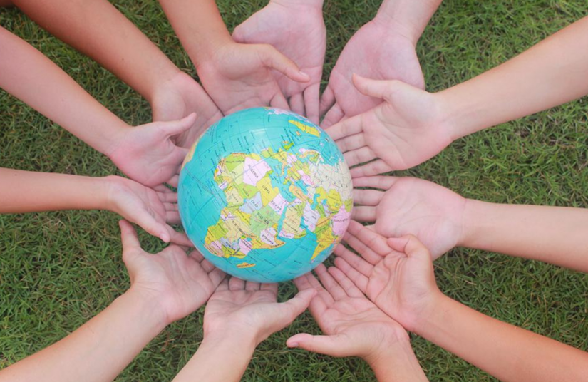 Hands holding a small globe