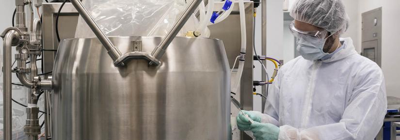 A scientist works with equipment in the biologics innovation facility.