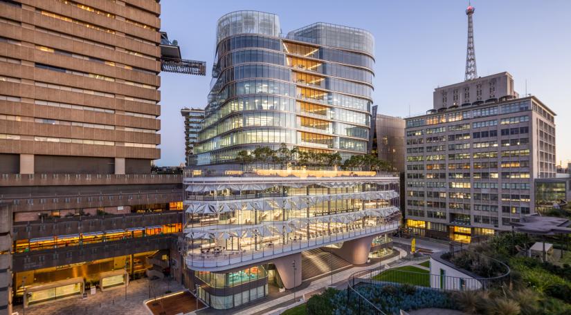 The glass-encased UTS Central building at twilight, from Alumni Green