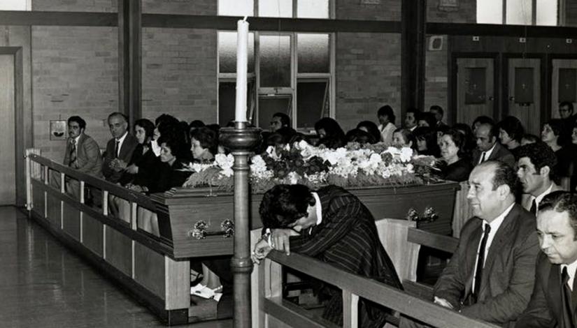 People gathering at funeral at a church, mourning the loss of a loved one