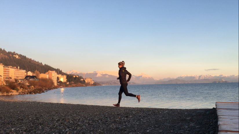 Alana running next to a beach