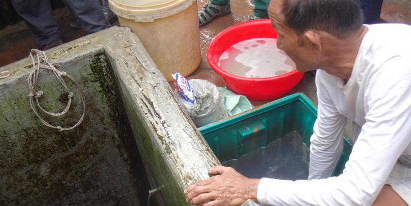 Resident in low-income urban area in Bangladesh with his self-developed water-supply. 