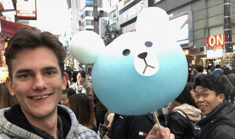 James holding up a bear made out of fairy floss