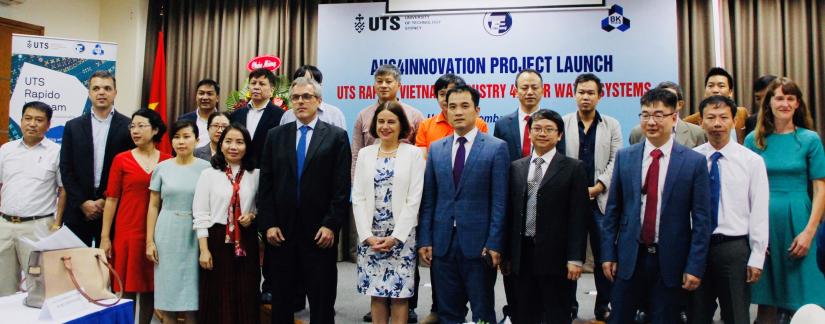 A group of people in front of a banner