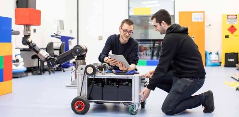 HDR students in lab with robot
